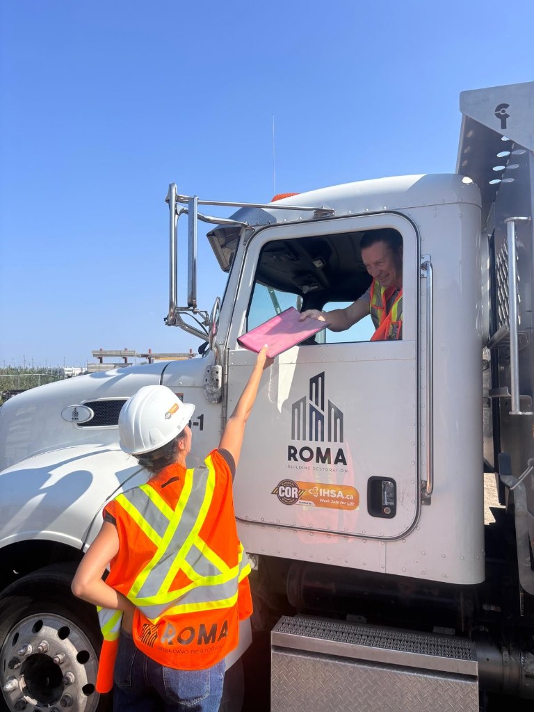 Roma team member sharing safety documents on site